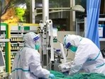 Medical staff in protective suits treat a patient with pneumonia Medical staff in protective suits treat a patient with pneumonia