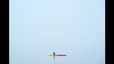 A man rows a canoe amid dense fog at the Dal Lake in Srinagar on Thursday. (AFP) A man rows a canoe amid dense fog at the Dal Lake in Srinagar on Thursday. (AFP)