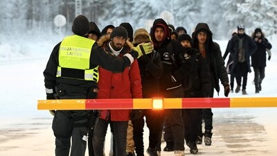 A Finnish Border Guard speaks to migrants at the international border crossing at Salla, northern Finland, on November 23, 2023. (AFP) A Finnish Border Guard speaks to migrants at the international border crossing at Salla, northern Finland, on November 23, 2023. (AFP)