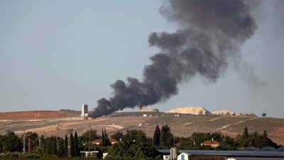 Flames and smoke rising from an agricultural structure in southern Lebanon's Khiam plain following Israeli bombardment. (AFP)