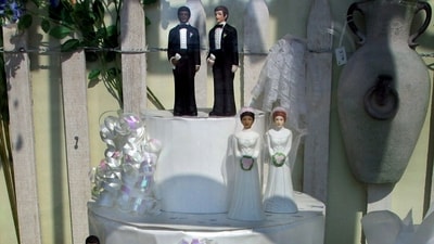 A window display at a wedding shop features figurines of the same sex paired together on a wedding cake. (AP/File Photo) A window display at a wedding shop features figurines of the same sex paired together on a wedding cake. (AP/File Photo)
