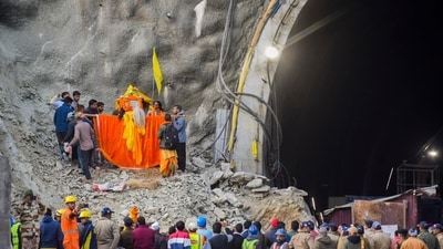 Uttarkashi: Locals carrying a deity on a palanquin offer prayers at the Silkyara Tunnel's entrance during the rescue operation of 41 workers trapped inside the tunnel (PTI) Uttarkashi: Locals carrying a deity on a palanquin offer prayers at the Silkyara Tunnel's entrance during the rescue operation of 41 workers trapped inside the tunnel (PTI)