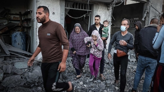 People flee following an Israeli strike in Rafah in the southern Gaza Strip on November 23, 2023. (AFP)
