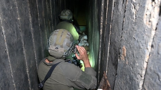 Soldiers walk through what the Israeli army says is a tunnel dug by Hamas militants inside the Al-Shifa hospital complex in Gaza City in the northern Gaza Strip, amid continuing battles between Israel and the Palestinian militant group Hamas Soldiers walk through what the Israeli army says is a tunnel dug by Hamas militants inside the Al-Shifa hospital complex in Gaza City in the northern Gaza Strip, amid continuing battles between Israel and the Palestinian militant group Hamas