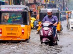 Commuters make their way amid rains on a waterlogged road, at Marina Beach in Chennai, Tamil Nadu. (PTI) Commuters make their way amid rains on a waterlogged road, at Marina Beach in Chennai, Tamil Nadu. (PTI)