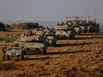 A convoy of Israeli military tanks and Armoured Personnel Carriers (APC) drives by Israel's border after leaving Gaza during the temporary truce between Palestinian Islamist group Hamas and Israel. (Reuters)