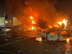 Flames rise from the car and a bus, set alight at the junction of Bachelors Walk and the O'Connell Bridge, in Dublin. (AFP)