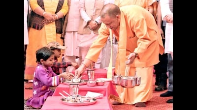 Chief minister Yogi Adityanath serving food to children at a composite school in Ayodhya, from where he inaugurated the Hot Cooked Meal Scheme on Friday. (Sourced) Chief minister Yogi Adityanath serving food to children at a composite school in Ayodhya, from where he inaugurated the Hot Cooked Meal Scheme on Friday. (Sourced)