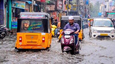 Commuters make their way amid rains on a waterlogged road, at Marina Beach in Chennai, Tamil Nadu. (PTI) Commuters make their way amid rains on a waterlogged road, at Marina Beach in Chennai, Tamil Nadu. (PTI)