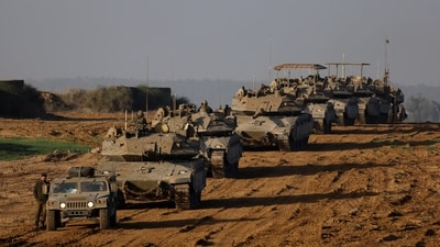 A convoy of Israeli military tanks and Armoured Personnel Carriers (APC) drives by Israel's border after leaving Gaza during the temporary truce between Palestinian Islamist group Hamas and Israel. (Reuters)