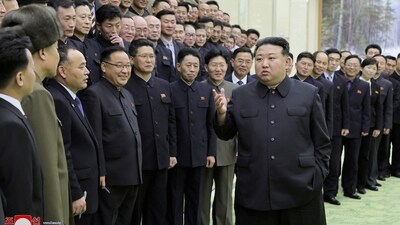 North Korea's leader Kim Jong-un meets with members of the Non-Standing Satellite Launch Preparation Committee. (Reuters)