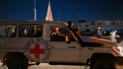 An International Red Cross vehicle reportedly carrying hostages released by Hamas crosses the Rafah border point in the Gaza Strip towards Egypt. (AFP) An International Red Cross vehicle reportedly carrying hostages released by Hamas crosses the Rafah border point in the Gaza Strip towards Egypt. (AFP)