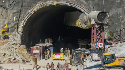 Security personnel and others at the under-construction Silkyara tunnel as drilling through the rubble to prepare an escape route for the 41 trapped workers remains stalled in Uttarkashi district on November 24. (PTI) Security personnel and others at the under-construction Silkyara tunnel as drilling through the rubble to prepare an escape route for the 41 trapped workers remains stalled in Uttarkashi district on November 24. (PTI)