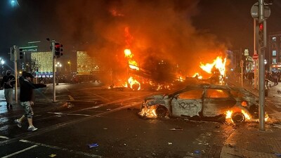 Flames rise from the car and a bus, set alight at the junction of Bachelors Walk and the O'Connell Bridge, in Dublin. (AFP) Flames rise from the car and a bus, set alight at the junction of Bachelors Walk and the O'Connell Bridge, in Dublin. (AFP)
