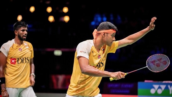 India's Satwiksairaj Rankireddy (L) and Chirag Shetty (R) play during their quarter final mens doubles match against Denmark's against Kim Astrup and Anders Skaarup Rasmussen (not pictured) at the BWF Badminton World Championsship (AFP)