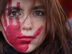 A woman attends a demonstration on the occasion of International Day for the Elimination of Violence against Women, in Milan, Italy.
