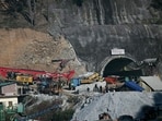 Rescue personnel move a digging machine during rescue operation for workers trapped in the Silkyara under construction road tunnel. Rescue personnel move a digging machine during rescue operation for workers trapped in the Silkyara under construction road tunnel.