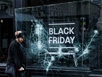 Dublin Knife Attack: A man works to remove a broken window from a sport shop that was damaged in a riot.