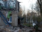 A police officer inspects a compound of a kindergarten damaged during Russian drone strikes, amid Russia's attack on Ukraine, in Kyiv, Ukraine November 25, 2023. REUTERS/Valentyn Ogirenko