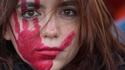A woman attends a demonstration on the occasion of International Day for the Elimination of Violence against Women, in Milan, Italy. (AP) A woman attends a demonstration on the occasion of International Day for the Elimination of Violence against Women, in Milan, Italy. (AP)
