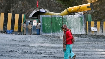 A woman walks past the collapsed under construction Silkyara tunnel in the Uttarkashi district of India's Uttarakhand state, on November 25, 2023. (AFP) A woman walks past the collapsed under construction Silkyara tunnel in the Uttarkashi district of India's Uttarakhand state, on November 25, 2023. (AFP)