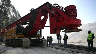 Rescue personnel move a digging machine during rescue operation for workers trapped in the Silkyara under construction road tunnel, days after it collapsed in the Uttarkashi district of India's Uttarakhand state. (AFP) Rescue personnel move a digging machine during rescue operation for workers trapped in the Silkyara under construction road tunnel, days after it collapsed in the Uttarkashi district of India's Uttarakhand state. (AFP)