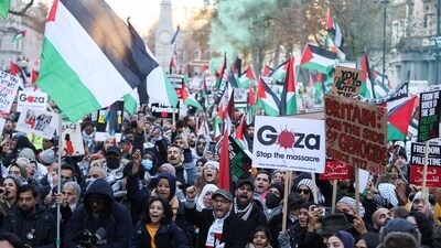 Demonstrators hold Palestinian flags and signs in Whitehall by the Cenotaph, during a protest in solidarity with Palestinians in Gaza. (REUTERS)