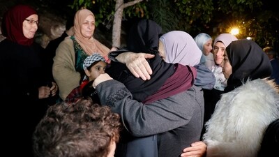 Family members welcome released Palestinian prisoner Fatima Amarneh, amid a hostages-prisoners swap deal between Hamas and Israel, near Jenin in the Israeli-occupied West Bank. (Reuters)