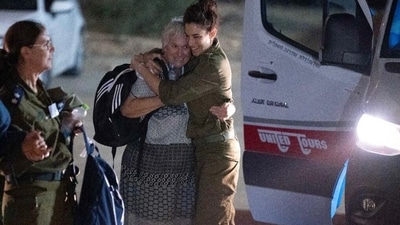 An Israeli soldier embracing former captive Margalit Moses upon her arrival in Israel, following her release by Hamas in Gaza. (AFP) An Israeli soldier embracing former captive Margalit Moses upon her arrival in Israel, following her release by Hamas in Gaza. (AFP)