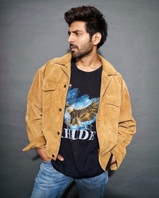 Kartik Aaryan looks stylish in a beige coloured Corduroy jacket paired wit a graphic T-shirt and denim. (Instagram) Kartik Aaryan looks stylish in a beige coloured Corduroy jacket paired wit a graphic T-shirt and denim. (Instagram)