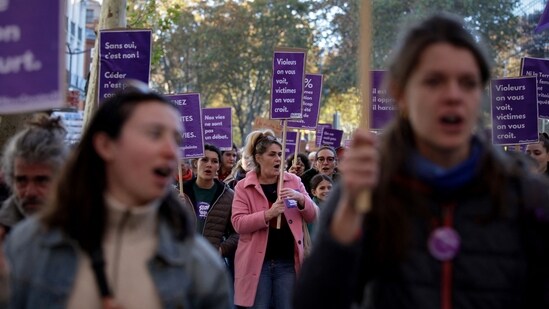 Women hold as they march during a demonstration to mark International Day for the Elimination of Violence Against Women in Toulouse, south-western France. (AFP)