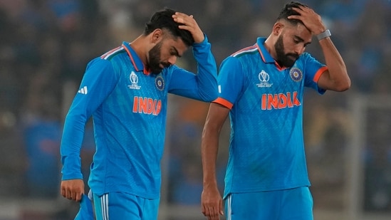 India's Virat Kohli, left, and Mohammed Siraj react after losing the ICC Men's Cricket World Cup final match against Australia. (AP)