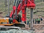 An earth-boring machine drills vertically into a mountain to rescue the 41 workers trapped in a collapsed tunnel in Silkyara in Uttarakhands on Sunday. (AFP)