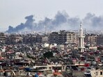 Smoke billows above buildings after an Israeli strike on the outskirts of Damascus 