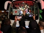 A bus transporting Red Cross staff and Palestinians prisoners released from Israeli jails in exchange for hostages released by Hamas from the Gaza Strip, drives through supporters holding flags in Ramallah in the occupied West Bank early on November 26, 2023. A bus transporting Red Cross staff and Palestinians prisoners released from Israeli jails in exchange for hostages released by Hamas from the Gaza Strip, drives through supporters holding flags in Ramallah in the occupied West Bank early on November 26, 2023.