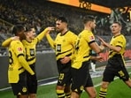 Jamie Bynoe-Gittens celebrates with his Borussia Dortmund teammates.