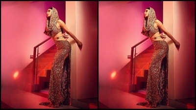 Her outfit features a shimmering gold fabric, an attached hoddie, a stylish cut-out pattern at the waist, a long trail at the back and a seductive thigh-high side slit that adds an extra touch of glamour. (Instagram/@imouniroy) Her outfit features a shimmering gold fabric, an attached hoddie, a stylish cut-out pattern at the waist, a long trail at the back and a seductive thigh-high side slit that adds an extra touch of glamour. (Instagram/@imouniroy)