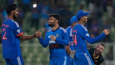 Australia's captain Matthew Wade, right, looks on as India players celebrate after Australia lost their second T20 cricket match against India in Thiruvananthapuram (AP) Australia's captain Matthew Wade, right, looks on as India players celebrate after Australia lost their second T20 cricket match against India in Thiruvananthapuram (AP)