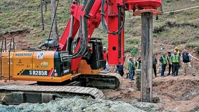 An earth-boring machine drills vertically into a mountain to rescue the 41 workers trapped in a collapsed tunnel in Silkyara in Uttarakhands on Sunday. (AFP) An earth-boring machine drills vertically into a mountain to rescue the 41 workers trapped in a collapsed tunnel in Silkyara in Uttarakhands on Sunday. (AFP)