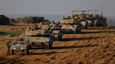 A convoy of Israeli military tanks and Armoured Personnel Carriers (APC) drives by Israel's border after leaving Gaza during the temporary truce between Palestinian Islamist group Hamas and Israel. ((Reuters))