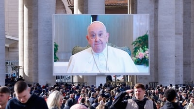 Pope Francis appears on a screen in St. Peter's Square as he leads the Angelus prayer from Santa Marta chapel at the Vatican, (REUTERS)