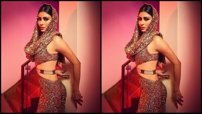 Mouni kept her accessories to a minimum to let her outfit take centre stage. She styled her look with a sleek grey belt at her waist and a pair of shiny gold Jimmy Choo heels. (Instagram/@imouniroy) Mouni kept her accessories to a minimum to let her outfit take centre stage. She styled her look with a sleek grey belt at her waist and a pair of shiny gold Jimmy Choo heels. (Instagram/@imouniroy)