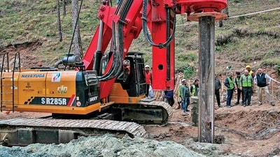 An earth-boring machine drills vertically into a mountain to rescue the 41 workers trapped in a collapsed tunnel in Silkyara in Uttarakhands on Sunday. (AFP) An earth-boring machine drills vertically into a mountain to rescue the 41 workers trapped in a collapsed tunnel in Silkyara in Uttarakhands on Sunday. (AFP)