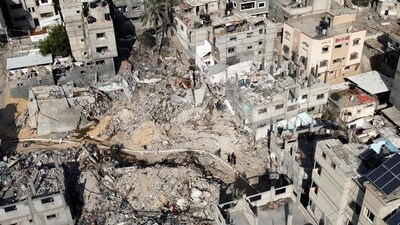 Israel-Hamas War: Palestinians walk among the rubble, as they inspect houses destroyed in Israeli strikes during the conflict, amid the temporary truce between Hamas and Israe. (Reuters)