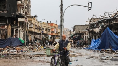 Israel-Hamas War: A Palestinian walks in Gaza City amid temporary ceasefire between Hamas and Israel. (AP) Israel-Hamas War: A Palestinian walks in Gaza City amid temporary ceasefire between Hamas and Israel. (AP)