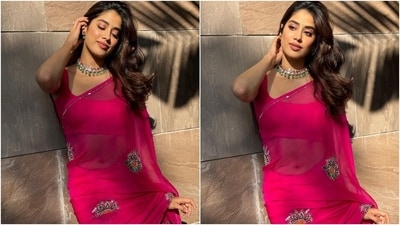 Janhvi Kapoor poses in a Rani pink chiffon saree and sleeveless blouse. (Instagram) Janhvi Kapoor poses in a Rani pink chiffon saree and sleeveless blouse. (Instagram)