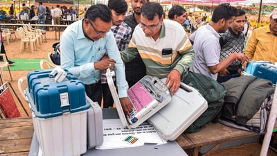 Polling officials collect EVMs and other election material (PTI) Polling officials collect EVMs and other election material (PTI)