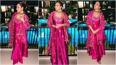 Sonakshi styled the ensemble with emerald and gold jewellery, including a choker, statement chandbalis, rings, and juttis. Lastly, she opted for a sleek top knot, winged eyeliner, pink eye shadow, mascara-adorned lashes, nude pink lip shade, a pink bindi, and a rouged glowing base to round off the glam picks. (Instagram) Sonakshi styled the ensemble with emerald and gold jewellery, including a choker, statement chandbalis, rings, and juttis. Lastly, she opted for a sleek top knot, winged eyeliner, pink eye shadow, mascara-adorned lashes, nude pink lip shade, a pink bindi, and a rouged glowing base to round off the glam picks. (Instagram)