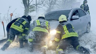 Emergency workers release a car which stuck in snow during a heavy snow storm in Odesa region, Ukraine in this handout picture released November 27, 2023. (via REUTERS)