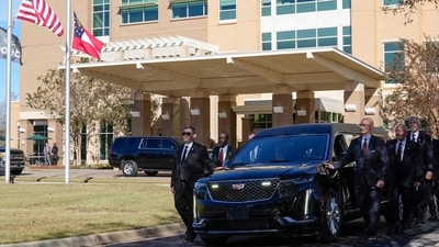 Former and current US Secret Service agents assigned to the Carter detail, walk next to the hearse carrying casket of former first lady Rosalynn Carter. (AFP) Former and current US Secret Service agents assigned to the Carter detail, walk next to the hearse carrying casket of former first lady Rosalynn Carter. (AFP)